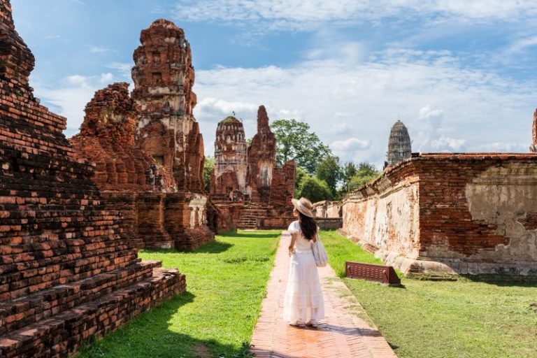 young-female-tourist-in-a-white-dress-walking-thro-2026-07-07-02-33-16-utc