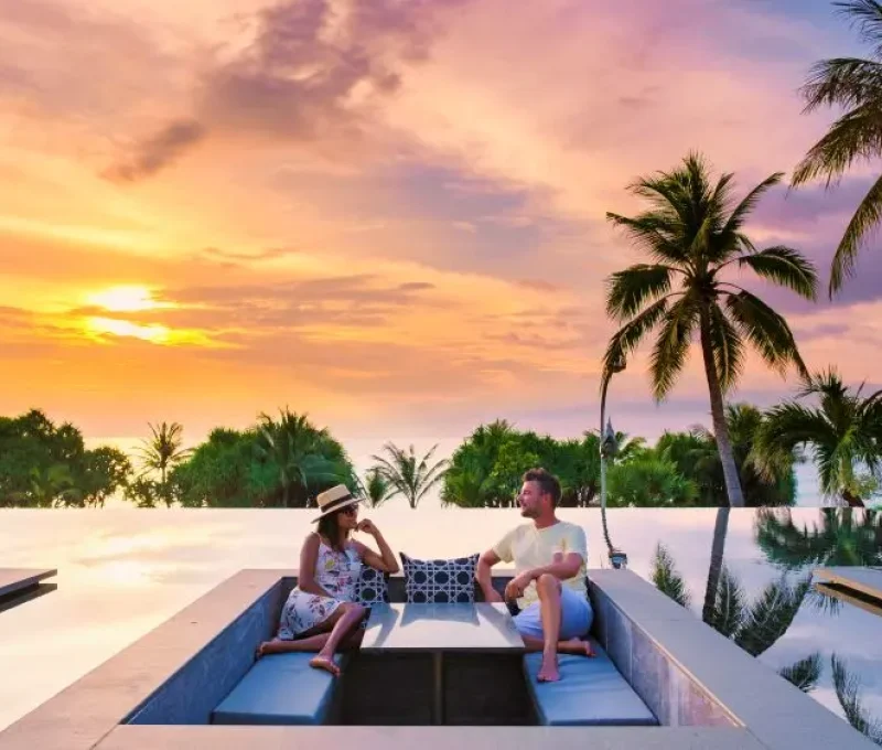 couple-watching-sunset-in-infinity-pool-on-a-luxury (1)