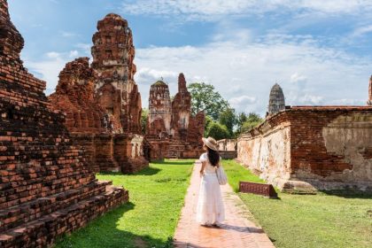 young-female-tourist-in-a-white-dress-walking-thro-2026-07-07-02-33-16-utc